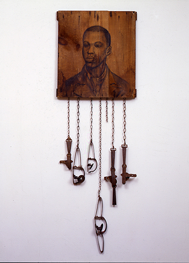 Whitfield Lovell (b. 1959). Trap, 2000. Charcoal on wood, animal traps, chains.